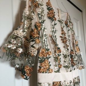 Embroidered floral midi dress with elbow sleeves.